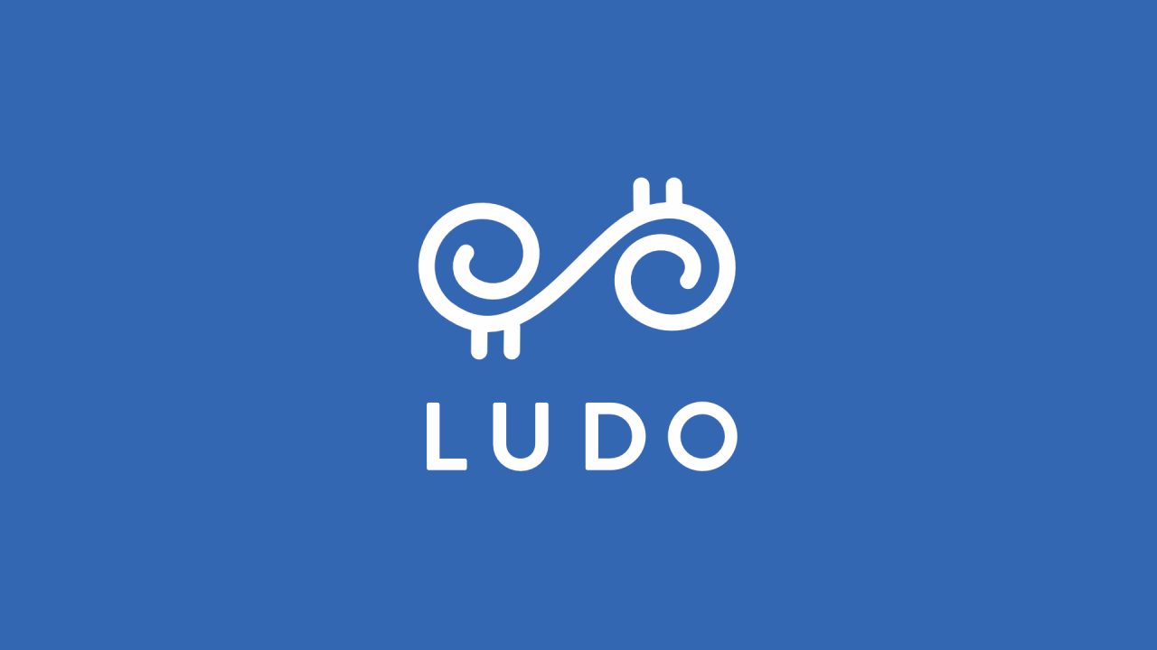 We Are Ludo logo: a white scrolled emblem and the word Ludo on a blue background